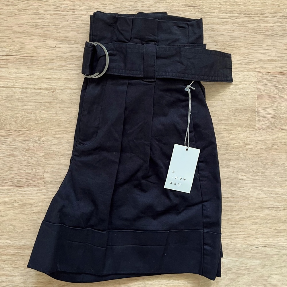 Black pleated shorts. New with tags. Size 2.